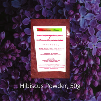natural purple hair dye, packet of hibiscus powder against a purple flower background