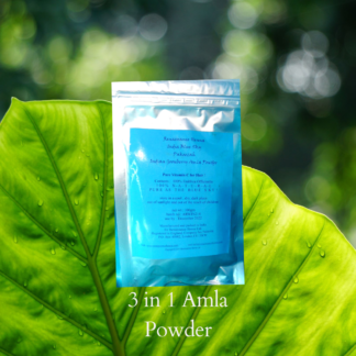 Image of silver foil sealed packet of Renaissance organic Amla powder with blue label against a green leaf background. Amla powder for helathy hair is packed with vitamin C and reputed to make hair grow,