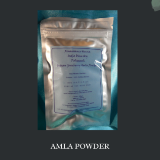 product image amla powder, silve rpacket with blue label against a dark background