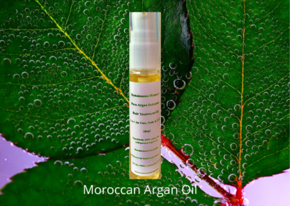 pure Moroccan argan oil, product image of oil bottle against a green leaf background with hints of lilac