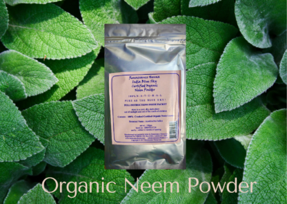 natural hair care product organic neem in silver foil packet with light pink label, displayed against a green leafy background