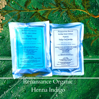 dark brown black hair dye: packets of Renaissnce organic henna & indigo against a green leaf and plant background