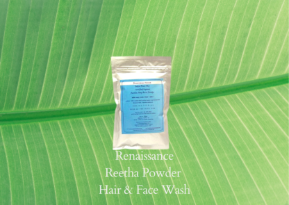 Plant shampoo Reetha powder in sealed foil packet with blue label against a green leaf background