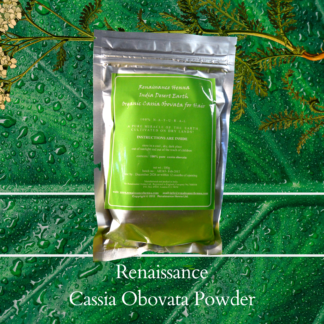 natural hair conditioner powder cassia obovata in sealed foil packet with green label, displayed against a green leaf background and green plant
