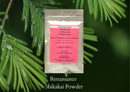 shikakai hair wash powder in a foil sealed packet with pink label, displayed against a green leaf background