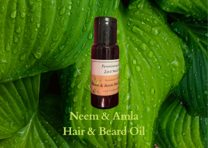 mens natural beard oil product image of small dark bottle of neem and amla natural hair care and beard oil, against a green leaf background