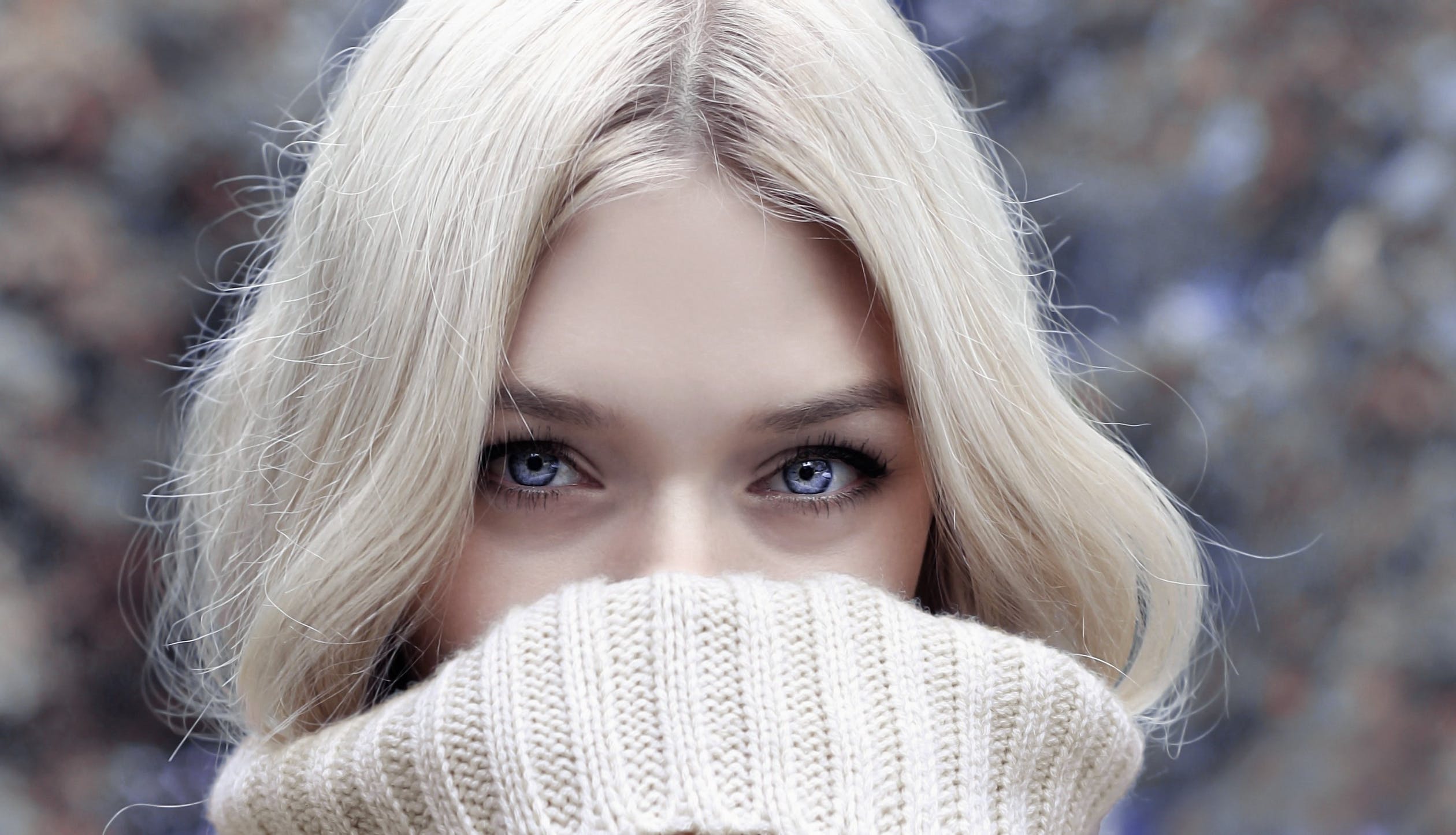 organic neem for healthy scalp and skin, blone woman with healthy scalp and skin wearing white polo neck covering part of her face