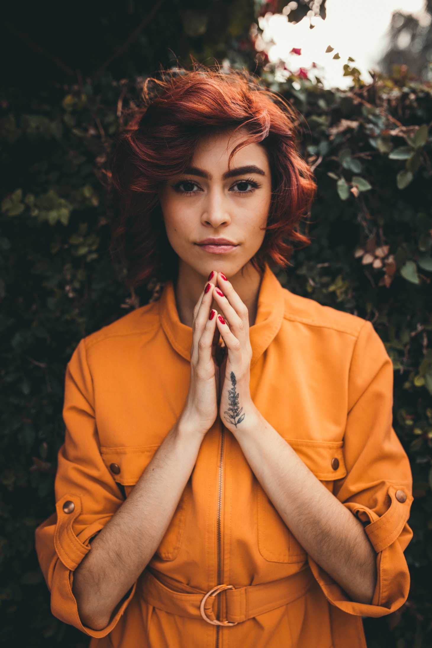 Is Henna Safe ? Ladies hands clasped together against background of orange coloured blouse