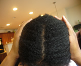 Sanya's afro-curly hair after henna and indigo, front parting view