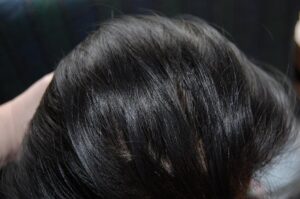 Gary's wife dark glossy hair side view